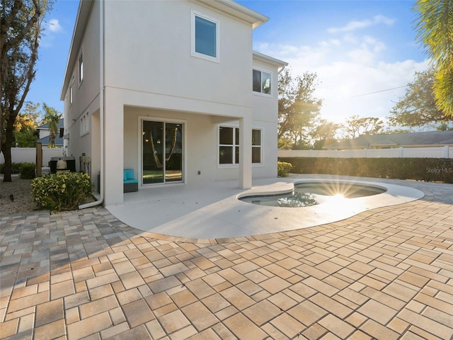 back of house featuring a fenced in pool and a patio area