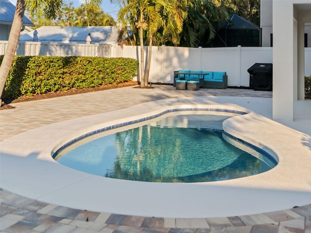 view of swimming pool featuring a grill and a patio area