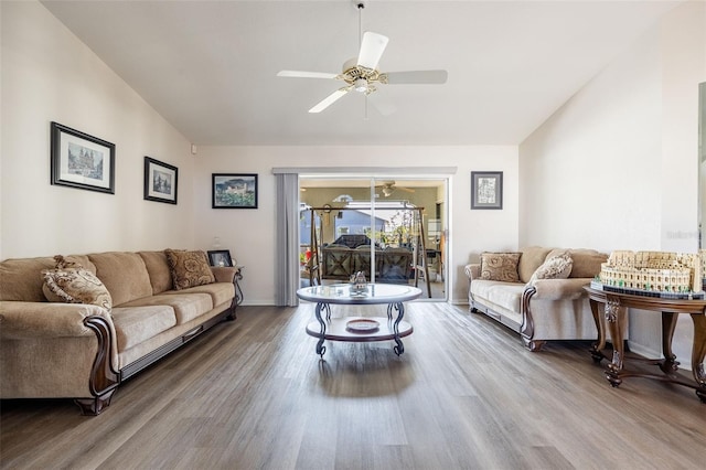 living room featuring hardwood / wood-style flooring, vaulted ceiling, and ceiling fan