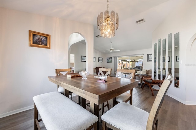 dining area featuring lofted ceiling, dark hardwood / wood-style floors, and ceiling fan with notable chandelier