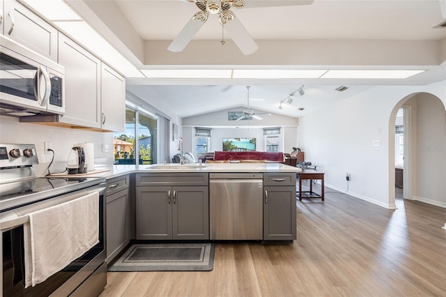 kitchen featuring sink, light wood-type flooring, gray cabinets, ceiling fan, and stainless steel appliances