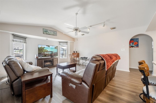 living room featuring lofted ceiling, a wealth of natural light, light hardwood / wood-style floors, and ceiling fan