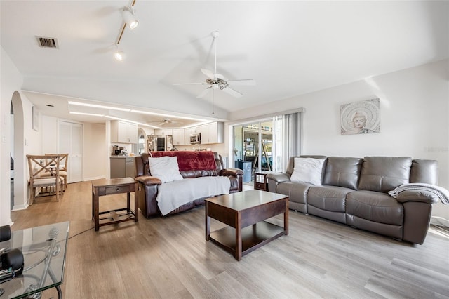 living room with ceiling fan, lofted ceiling, light wood-type flooring, and rail lighting