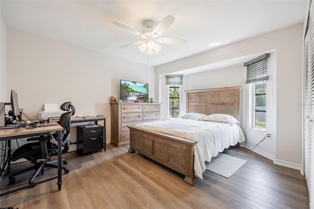 bedroom with ceiling fan and light hardwood / wood-style flooring