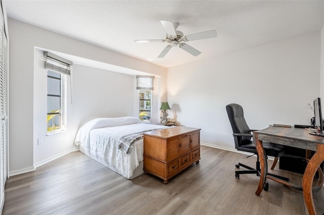 bedroom with ceiling fan and light hardwood / wood-style floors