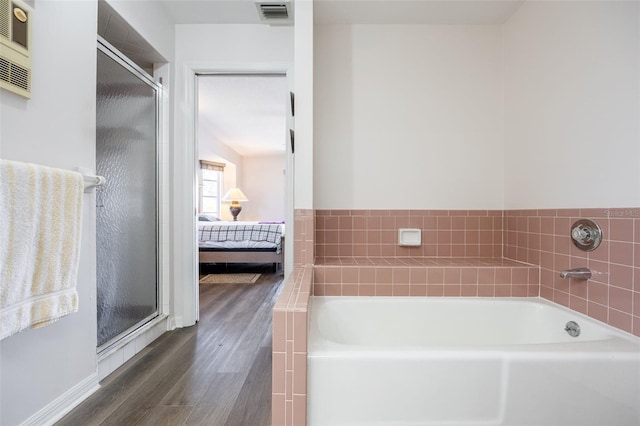 bathroom with plus walk in shower and hardwood / wood-style floors