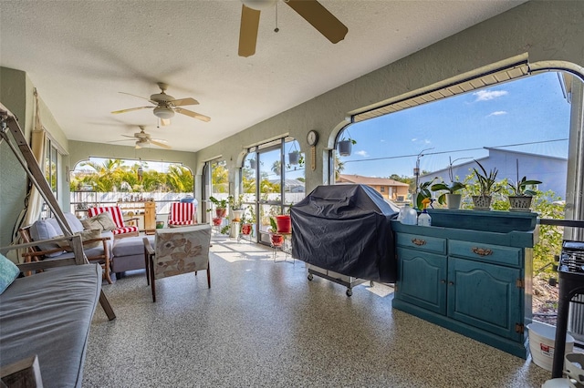 sunroom / solarium featuring ceiling fan