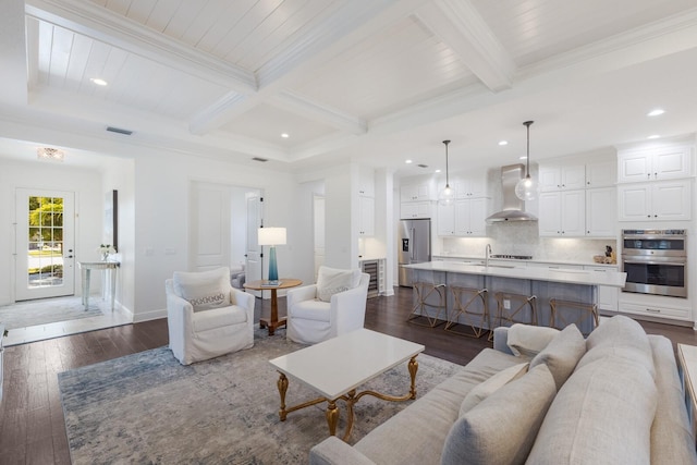 living room with crown molding, beam ceiling, dark wood-type flooring, and coffered ceiling