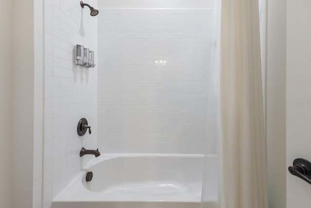 bathroom with shower / bath combination with curtain