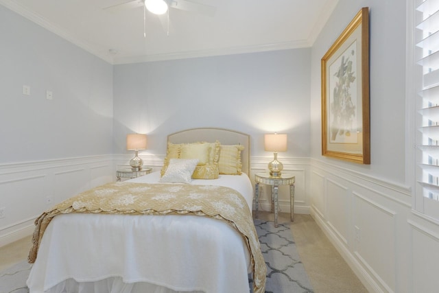 bedroom featuring light carpet, crown molding, and ceiling fan