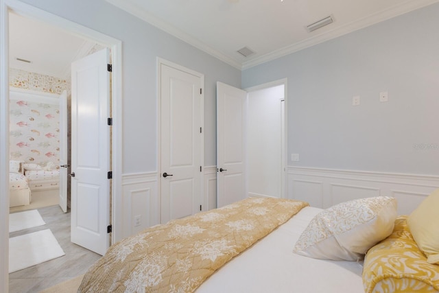 bedroom featuring crown molding and a closet