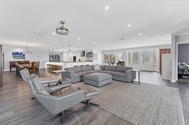 living room featuring crown molding and wood-type flooring