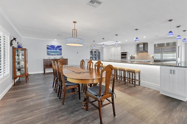 dining area featuring ornamental molding and dark hardwood / wood-style flooring