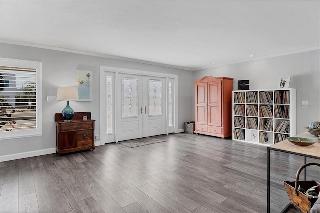 foyer entrance with french doors, ornamental molding, and hardwood / wood-style flooring