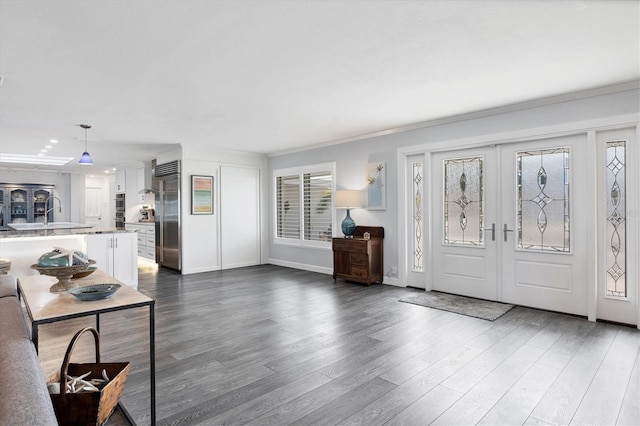 entrance foyer featuring french doors, ornamental molding, and wood-type flooring