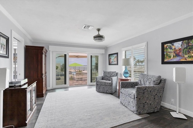 living area with ornamental molding and dark hardwood / wood-style floors