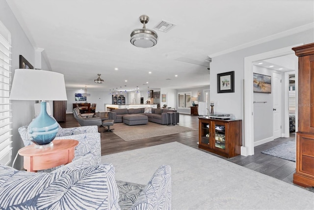 living room featuring crown molding and dark hardwood / wood-style floors