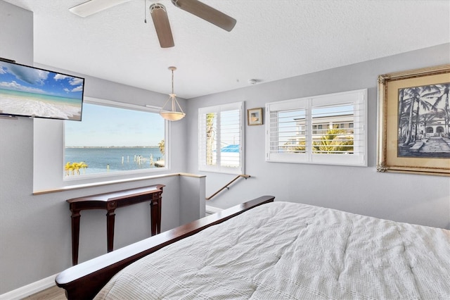 bedroom featuring a textured ceiling and ceiling fan