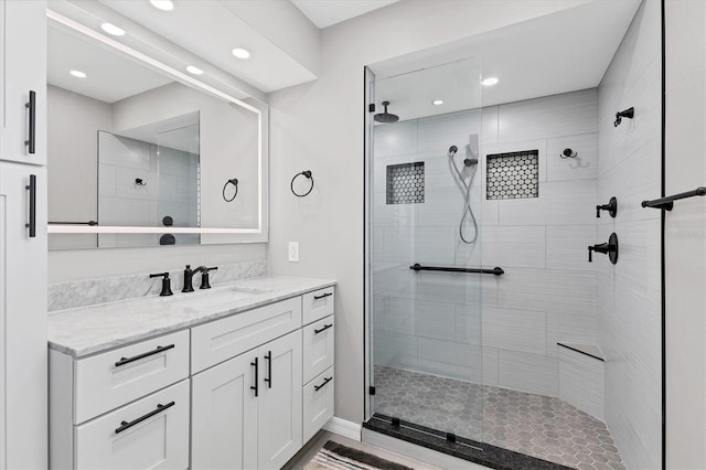 bathroom featuring vanity and tiled shower