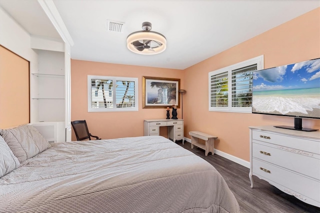 bedroom with dark hardwood / wood-style flooring