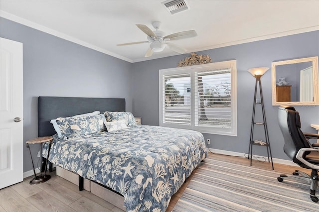 bedroom featuring crown molding, ceiling fan, and light hardwood / wood-style floors