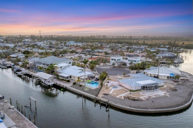 aerial view at dusk with a water view