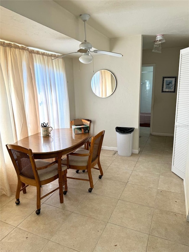 tiled dining area featuring a healthy amount of sunlight and ceiling fan