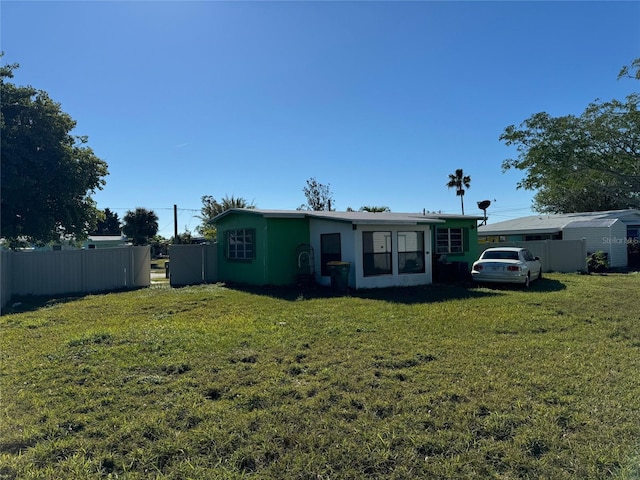 back of house with a lawn