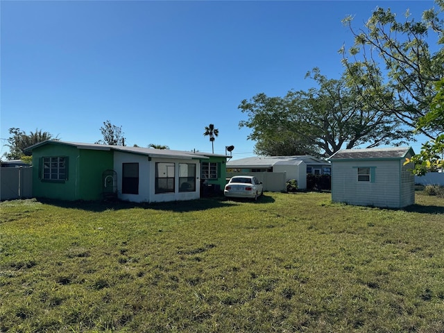 rear view of house featuring a lawn