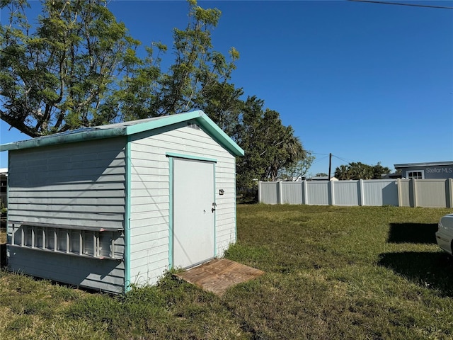 view of outdoor structure featuring a lawn