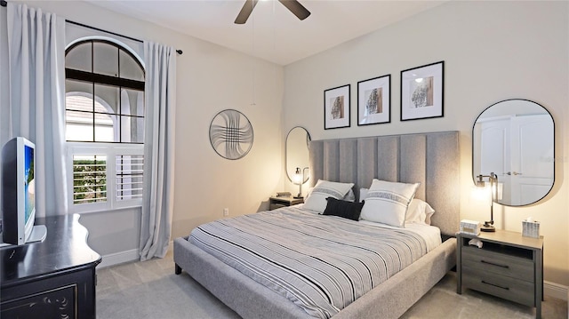 bedroom featuring light colored carpet and ceiling fan