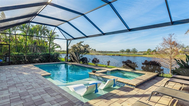 view of swimming pool with a lanai, a patio area, an in ground hot tub, and a water view