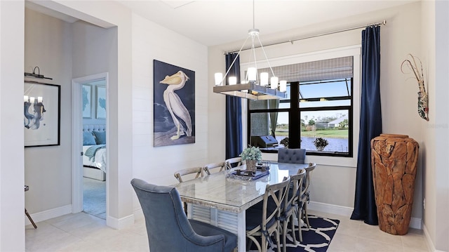 dining space with a notable chandelier and light tile patterned floors