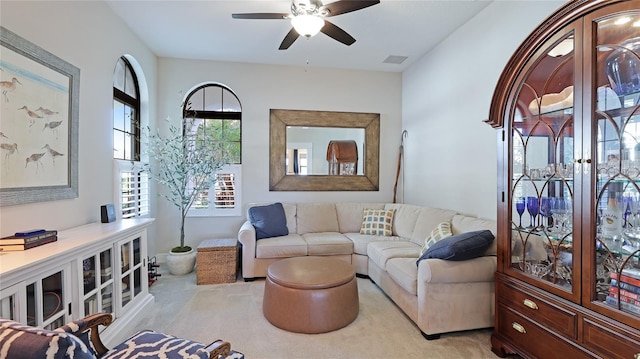 living room with ceiling fan and light carpet