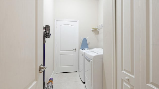 washroom with washer and clothes dryer and light tile patterned flooring