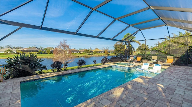 view of pool featuring an in ground hot tub, a water view, glass enclosure, and a patio