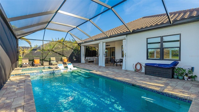 view of swimming pool with an in ground hot tub, an outdoor hangout area, a patio area, and a lanai