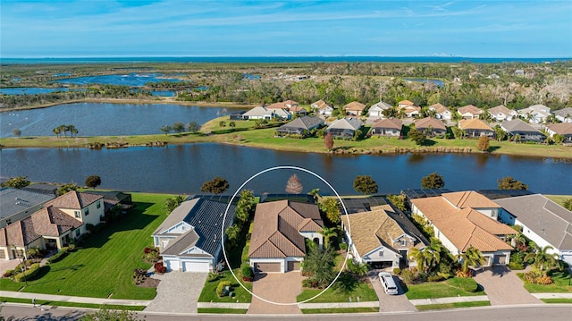 birds eye view of property with a water view