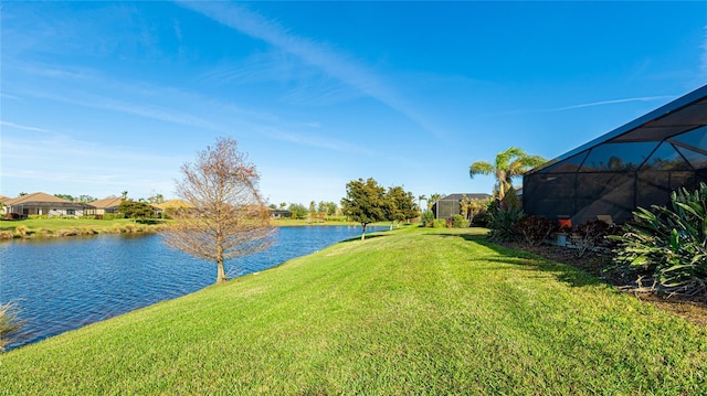 view of yard with a water view and a lanai