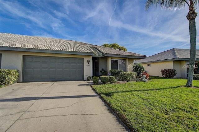 single story home with a garage and a front lawn