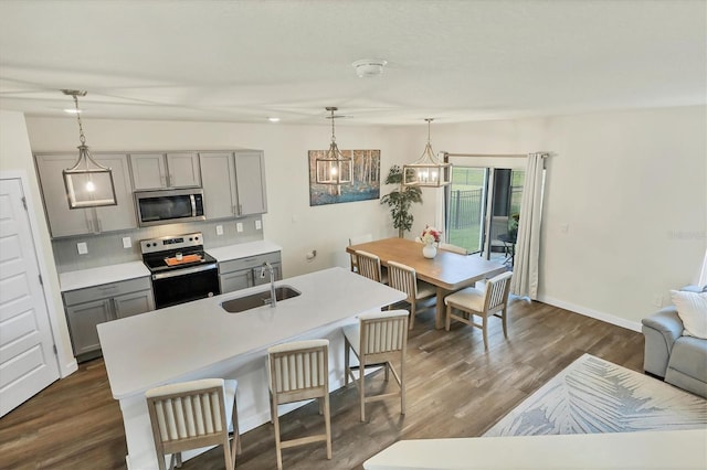 kitchen with sink, decorative light fixtures, gray cabinets, and stainless steel appliances