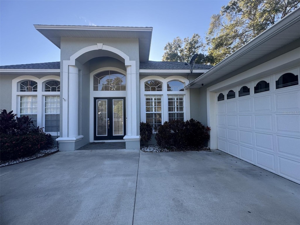 doorway to property with french doors and a garage