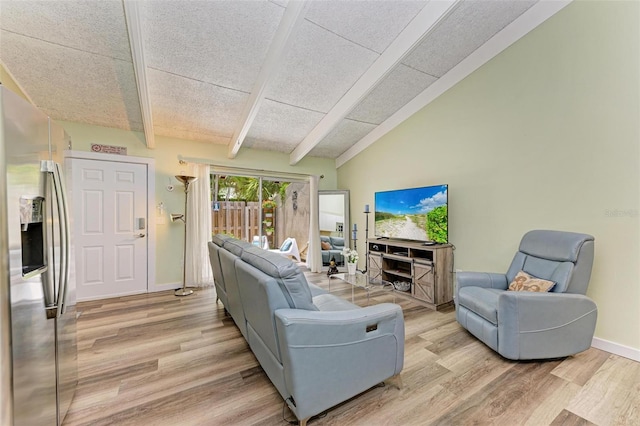 living room with vaulted ceiling with beams and light hardwood / wood-style floors