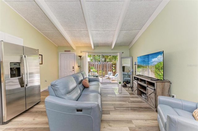 living room featuring vaulted ceiling with beams and light hardwood / wood-style floors