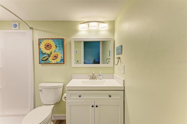 bathroom featuring vanity, a shower, and toilet