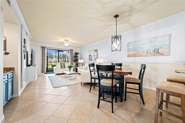 dining area with crown molding, light tile patterned floors, and ceiling fan