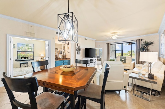 tiled dining space featuring ornamental molding and ceiling fan