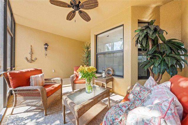 sunroom / solarium featuring ceiling fan