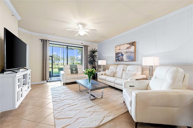 living room with ornamental molding, light tile patterned floors, and ceiling fan