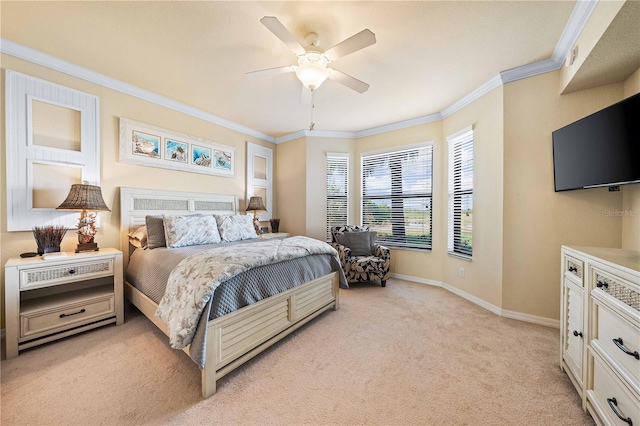 carpeted bedroom with ornamental molding and ceiling fan